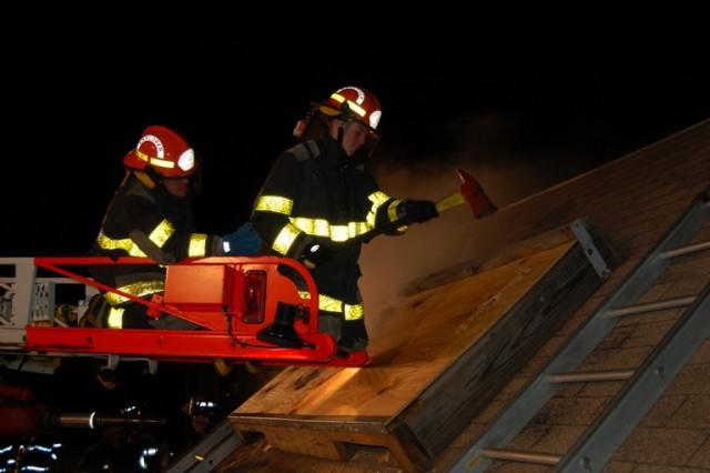 Randy Eckensberger and Zack Motta practice cutting a vent hole.